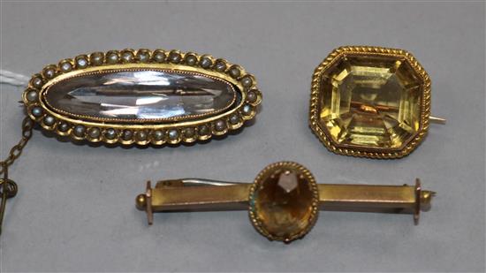 Three yellow metal and gem set brooches, including one stamped 9ct and one rock crystal and seed pearl bar brooch, largest 42mm.